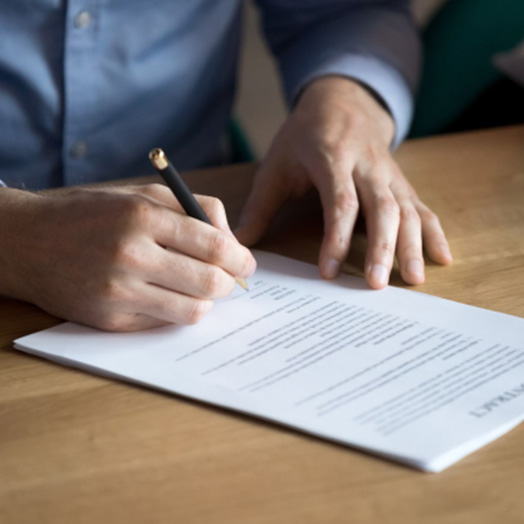 A man signing a contract.